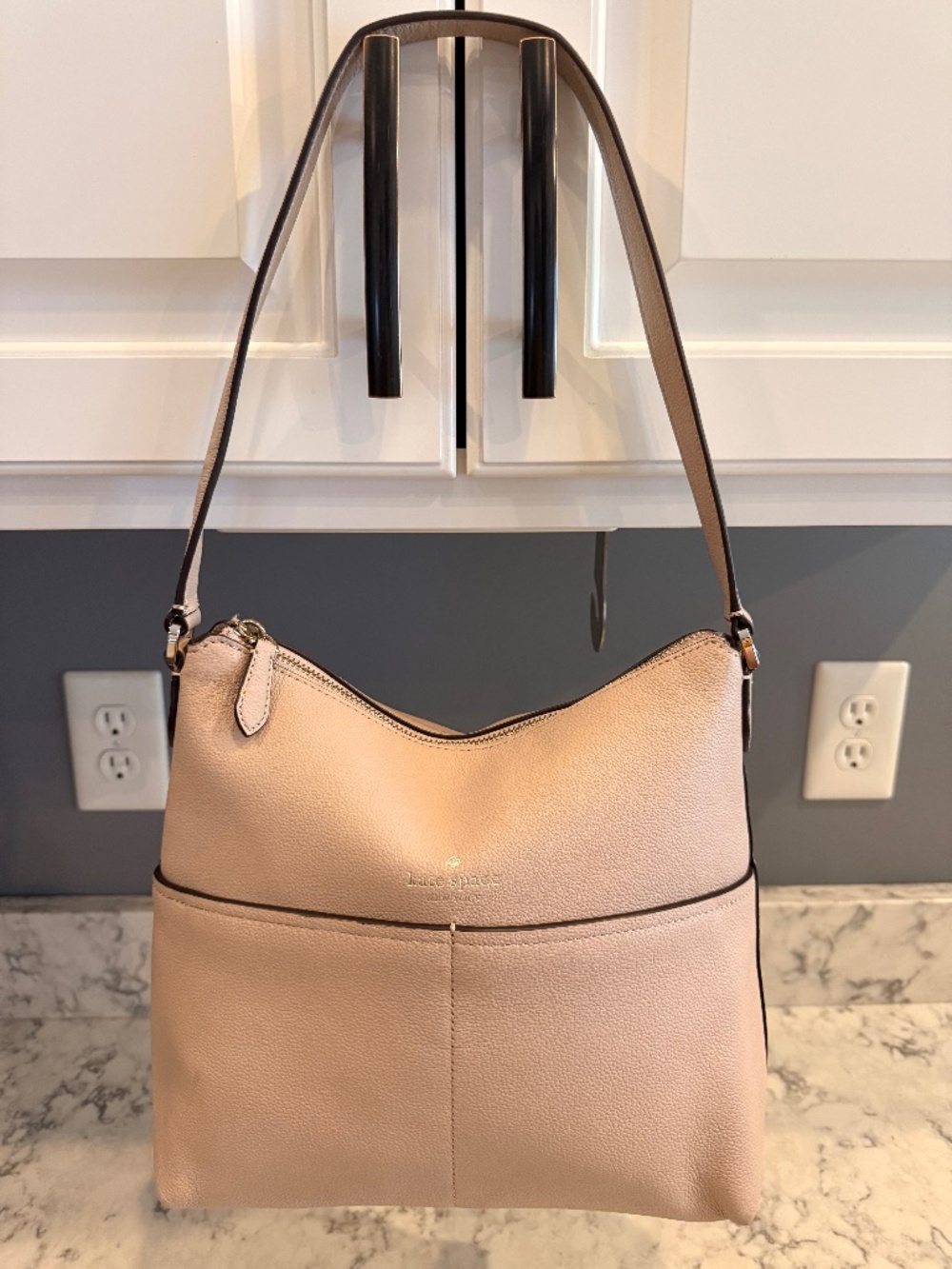 New Kate Spade bucket purse with 2 front pockets. Tan leather. New W/O tags